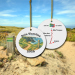 Rota Vicentina ceramic ornament with watercolor landscape shown front and back in front of trail landscape.