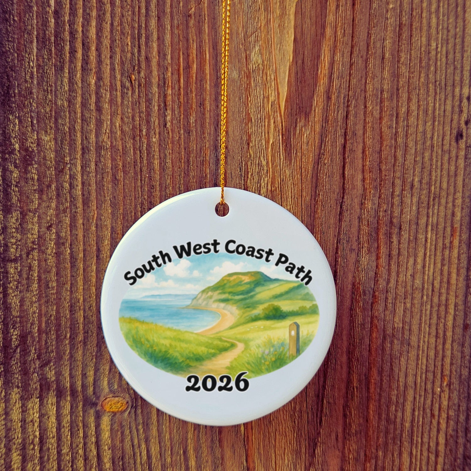 Basic version of South West Coast Path ornament in front of wooden door.