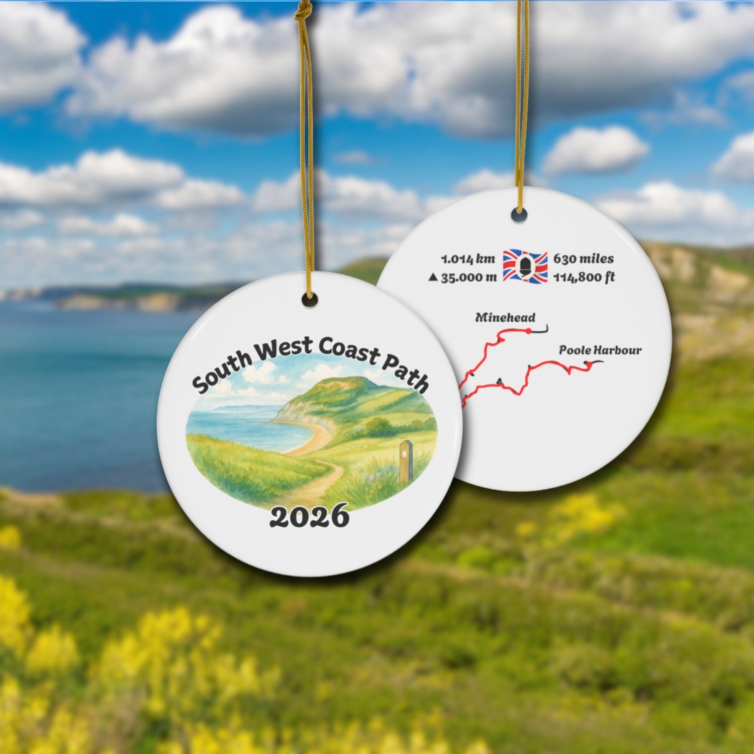South West Coast Path ceramic ornament with watercolor landscape shown front and back in front of trail landscape.