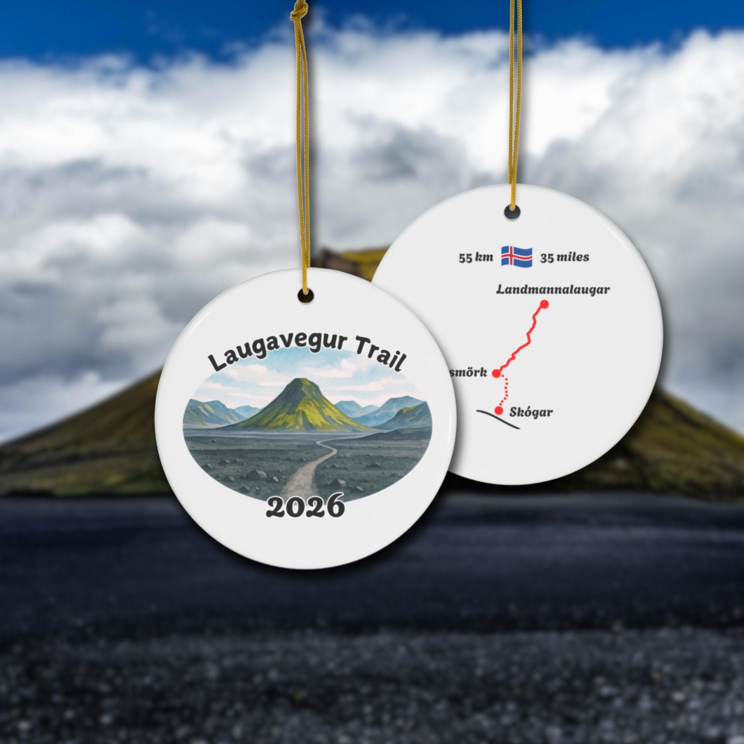 Laugavegur Trail ceramic ornament with watercolor landscape shown front and back in front of trail landscape.