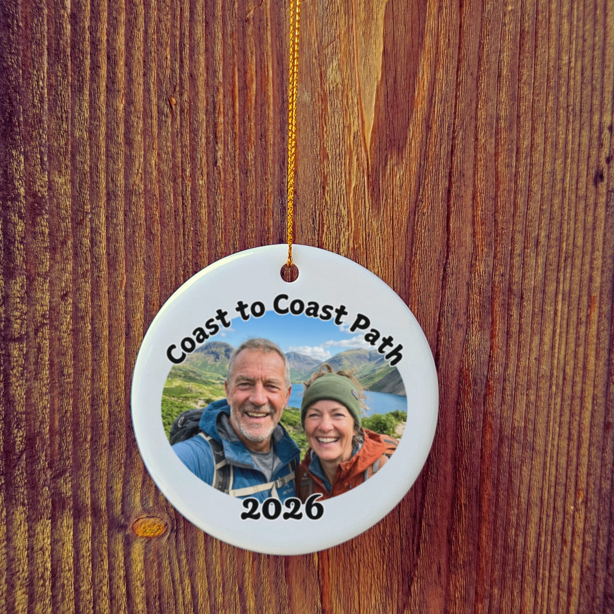 Photo version of Coast to Coast Path ornament in front of wooden door.
