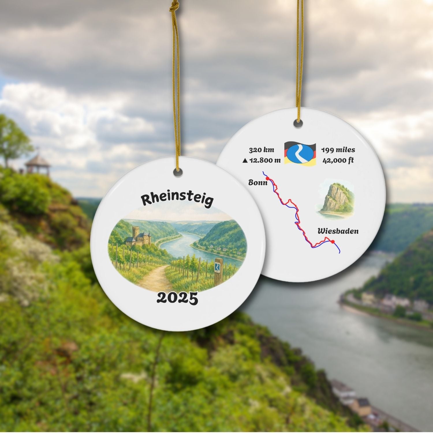 Front and back of the Rheinsteig keepsake ornament with vineyard watercolor scene and stylized trail map. Shown against a scenic Rhine Valley backdrop.