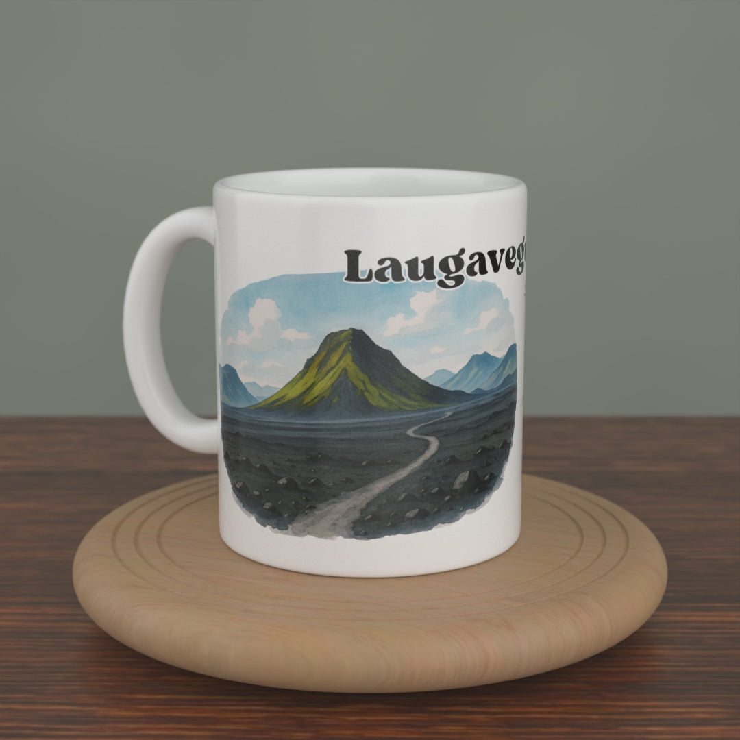 Video of a white Laugavegur Trail mug turning slowly, showing both editions: the watercolour map and the photo version.
