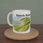 Video of a white South West Coast Path mug turning slowly, showing both editions: the watercolour map and the photo version.
